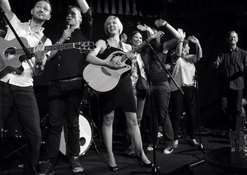 Melanie Lowe performing original music at an intimate live show