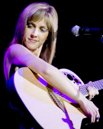 Melanie Lowe behind the scenes with guitar